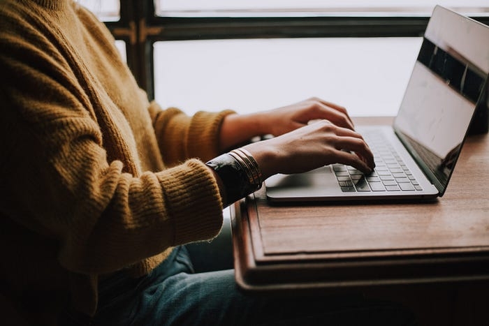 A person sitting working at a laptop.